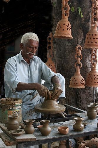 Artisan hand-knotting a carpet